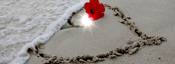 Heart in the sand with poppy Facebook Covers